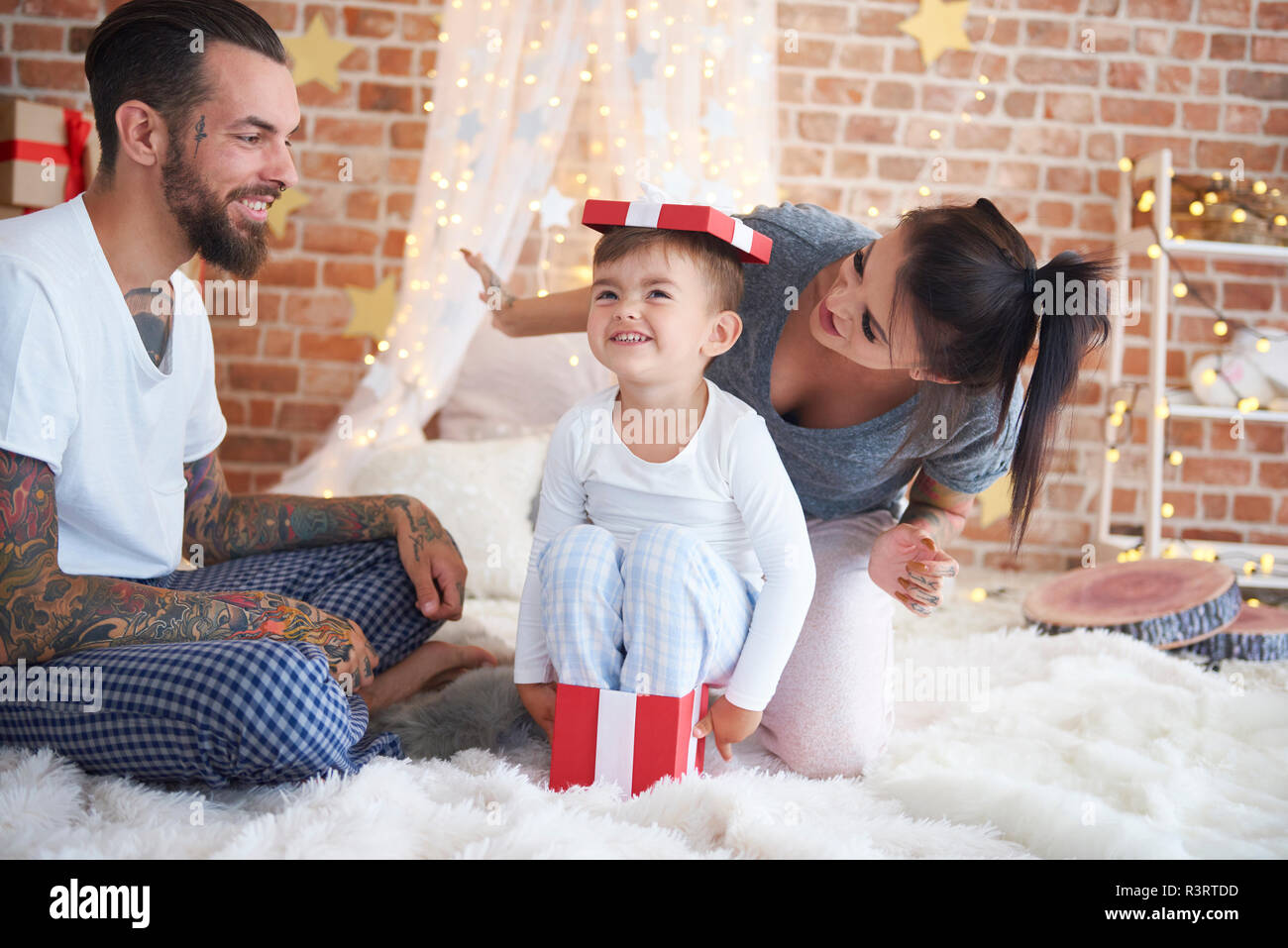 Happy family having fun at Christmas time in bed Stock Photo