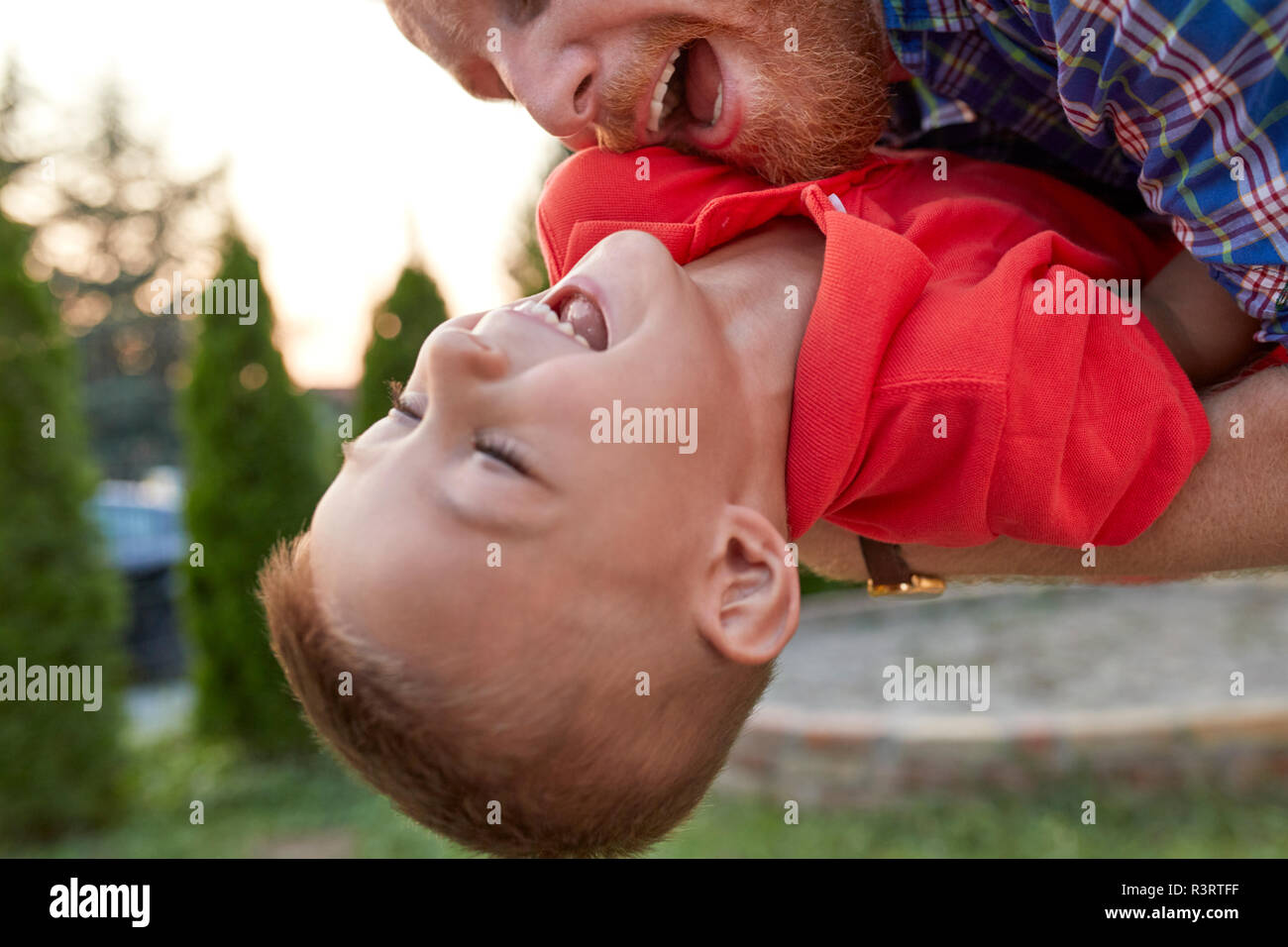 Happy playful father with his son in garden Stock Photo
