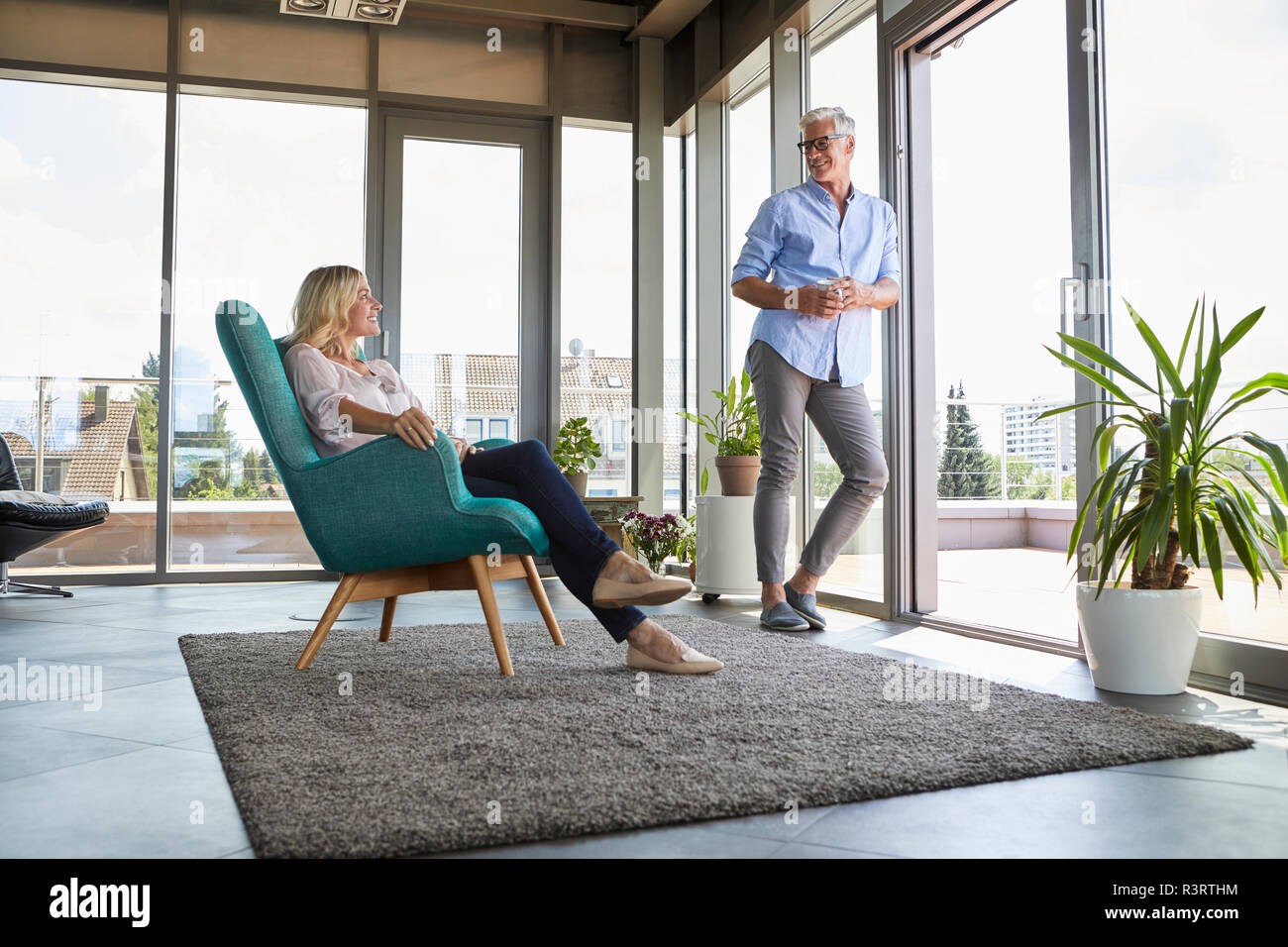 Smiling mature couple relaxing at home Stock Photo