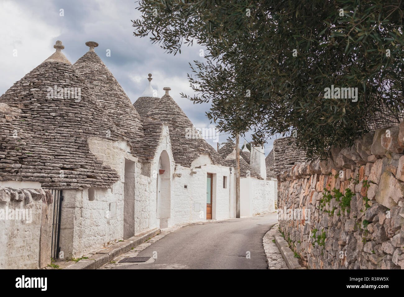 Italy, Apulia, Alberobello, view to alley with typically Trulli Stock Photo