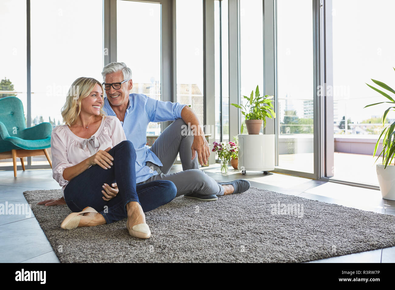 Smiling mature couple relaxing at home Stock Photo