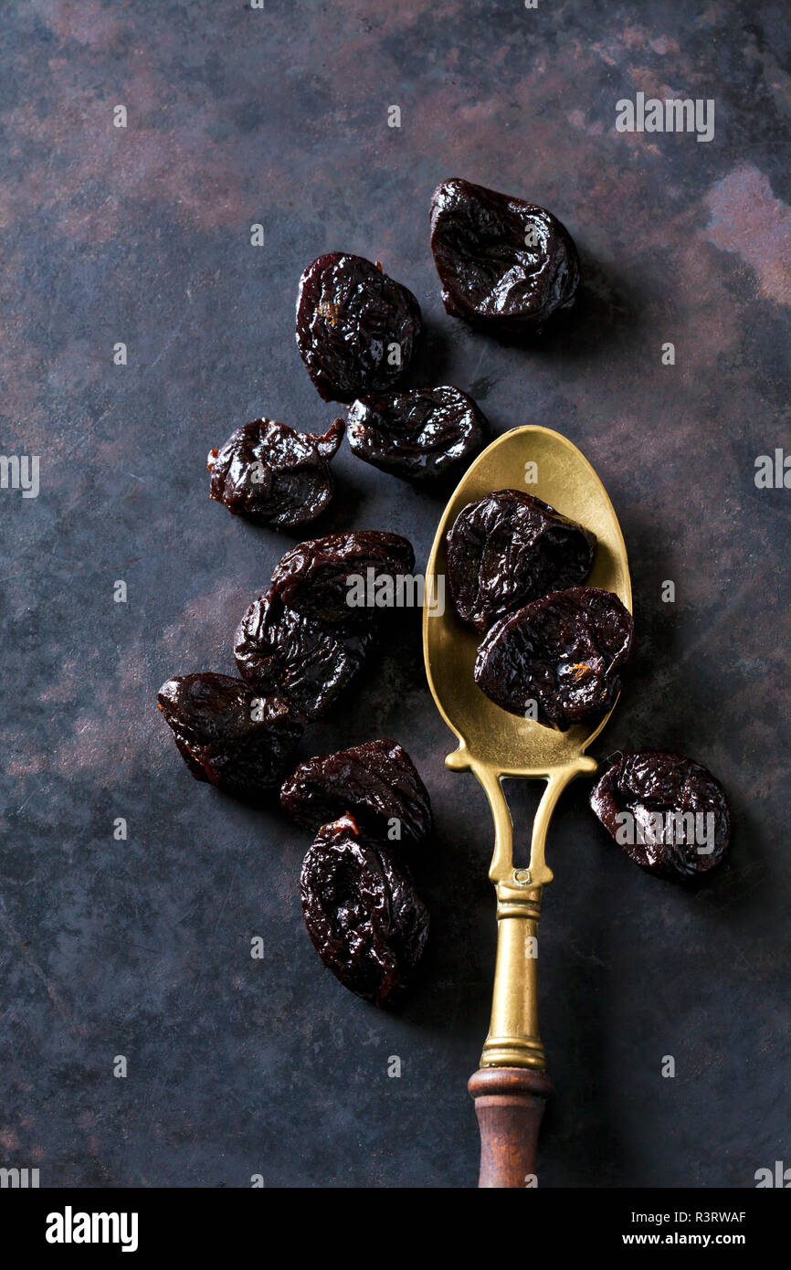 Prunes on a vintage brass spoon Stock Photo