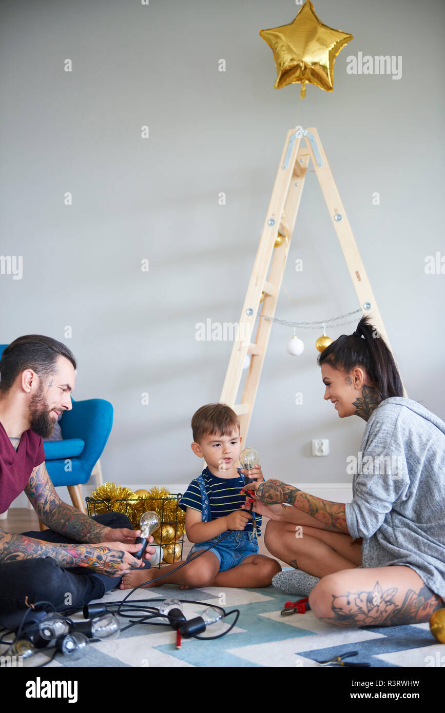 Happy modern family decorating the home at Christmas time Stock Photo