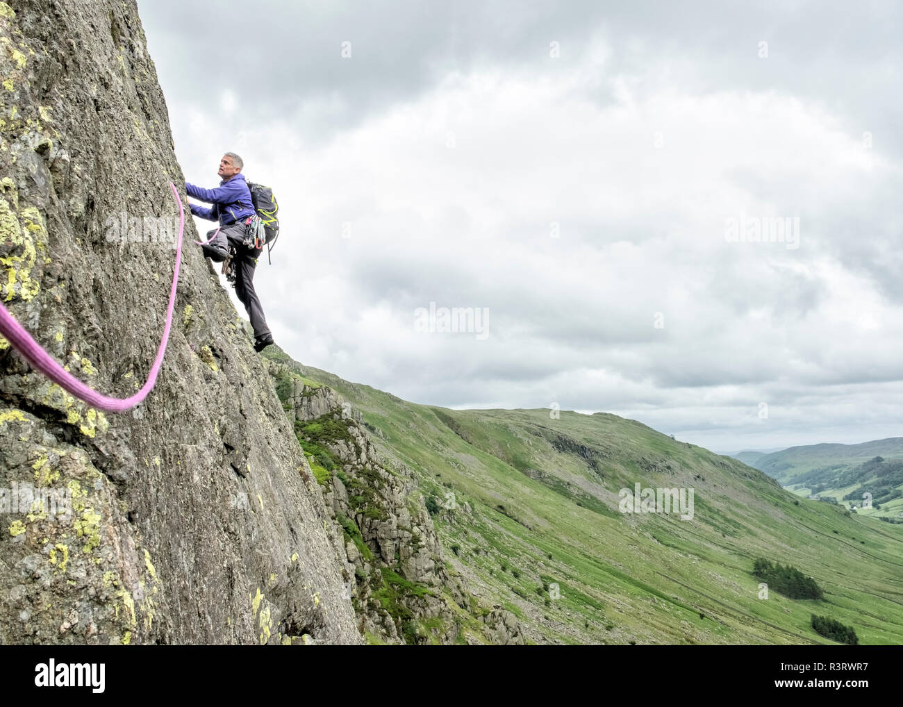UK, Lake District, Longsleddale valley, Buckbarrow Crag, man climbing in rock wall Stock Photo