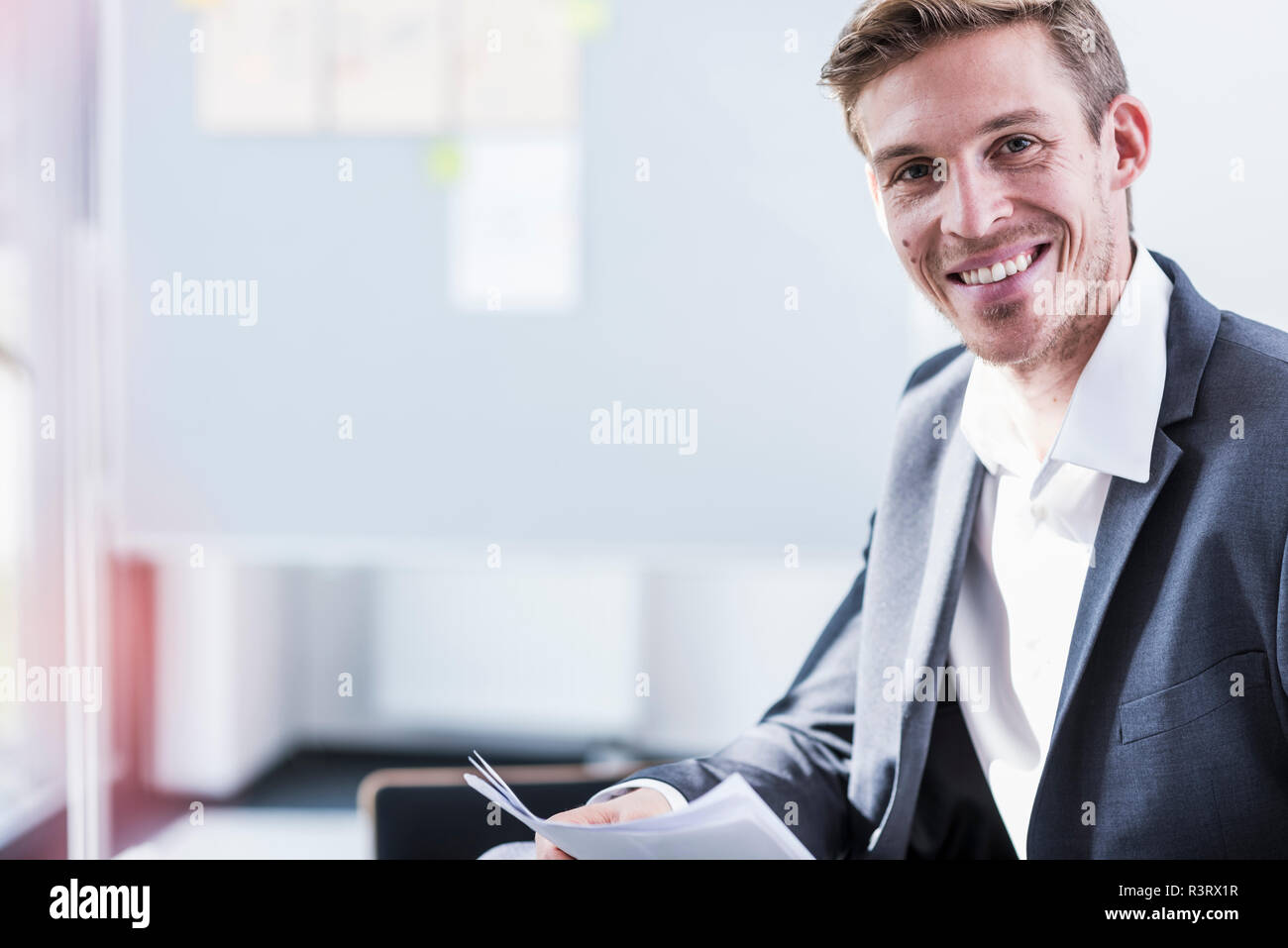 Portrait of smiling businessman in office Stock Photo