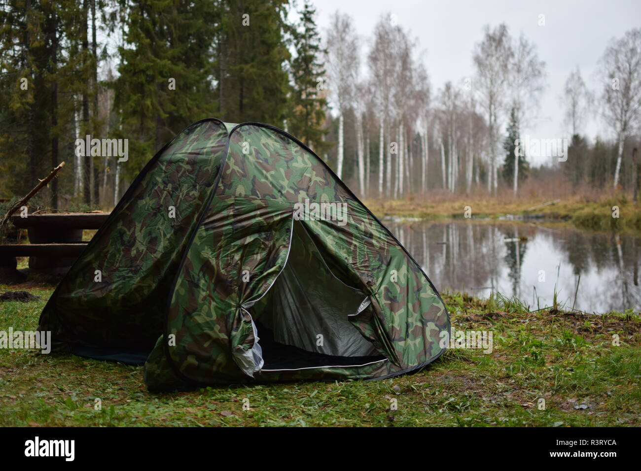 Tent in a forest with a lake Stock Photo - Alamy