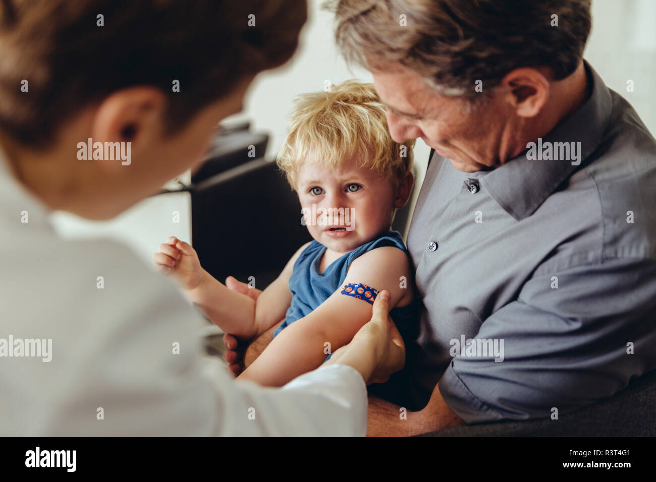 Father and son consulting a pedeatrician Stock Photo