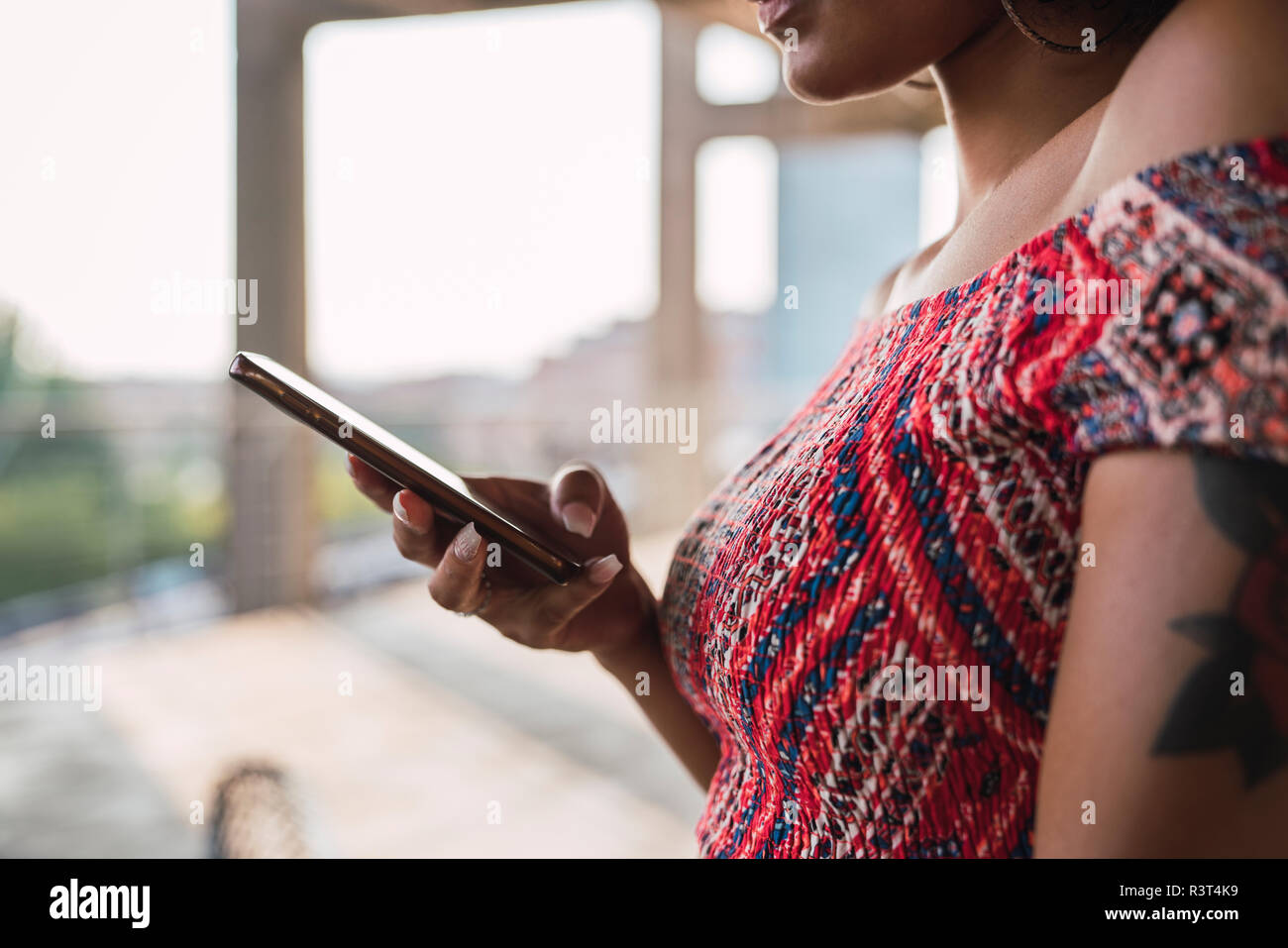 Woman using cell phone, partial view Stock Photo