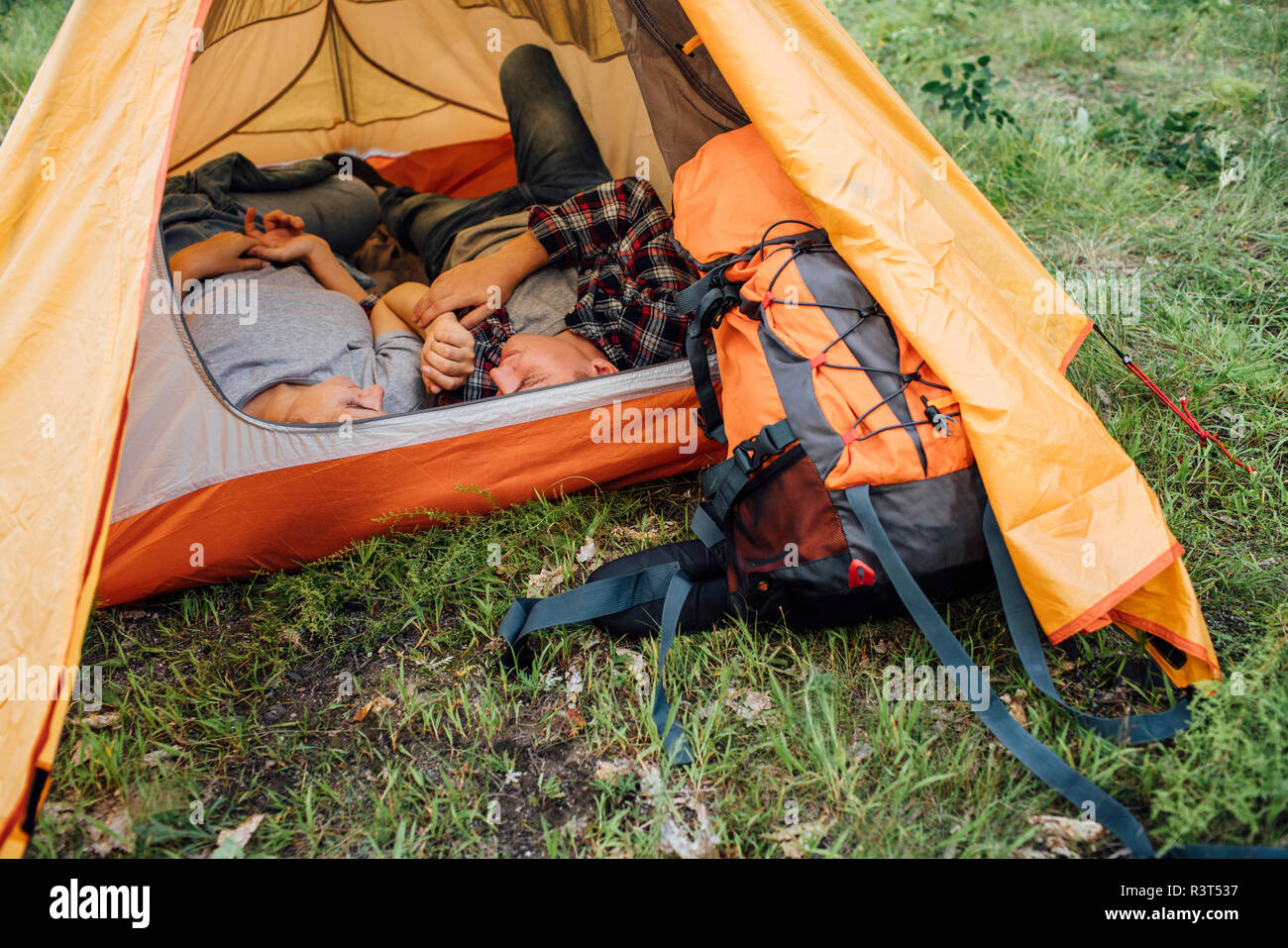 Young couple napping in tent Stock Photo