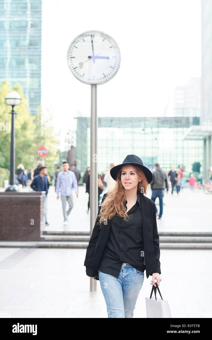 Mid adult woman wearing a hat going shopping in the city Stock Photo