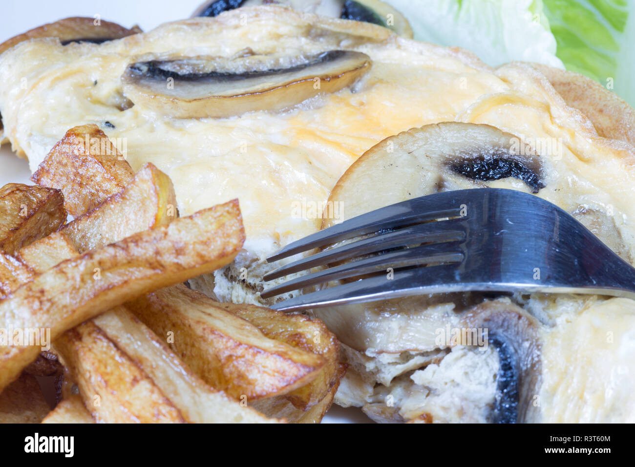A plated meal of Mushroom omelette with chips/fries Stock Photo