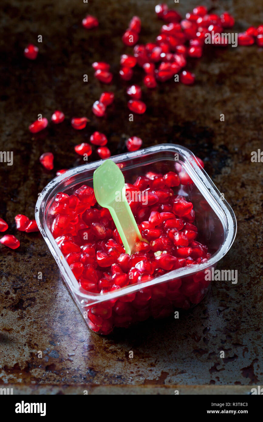 Pomegranate seed and plastic spoon in plastic box Stock Photo