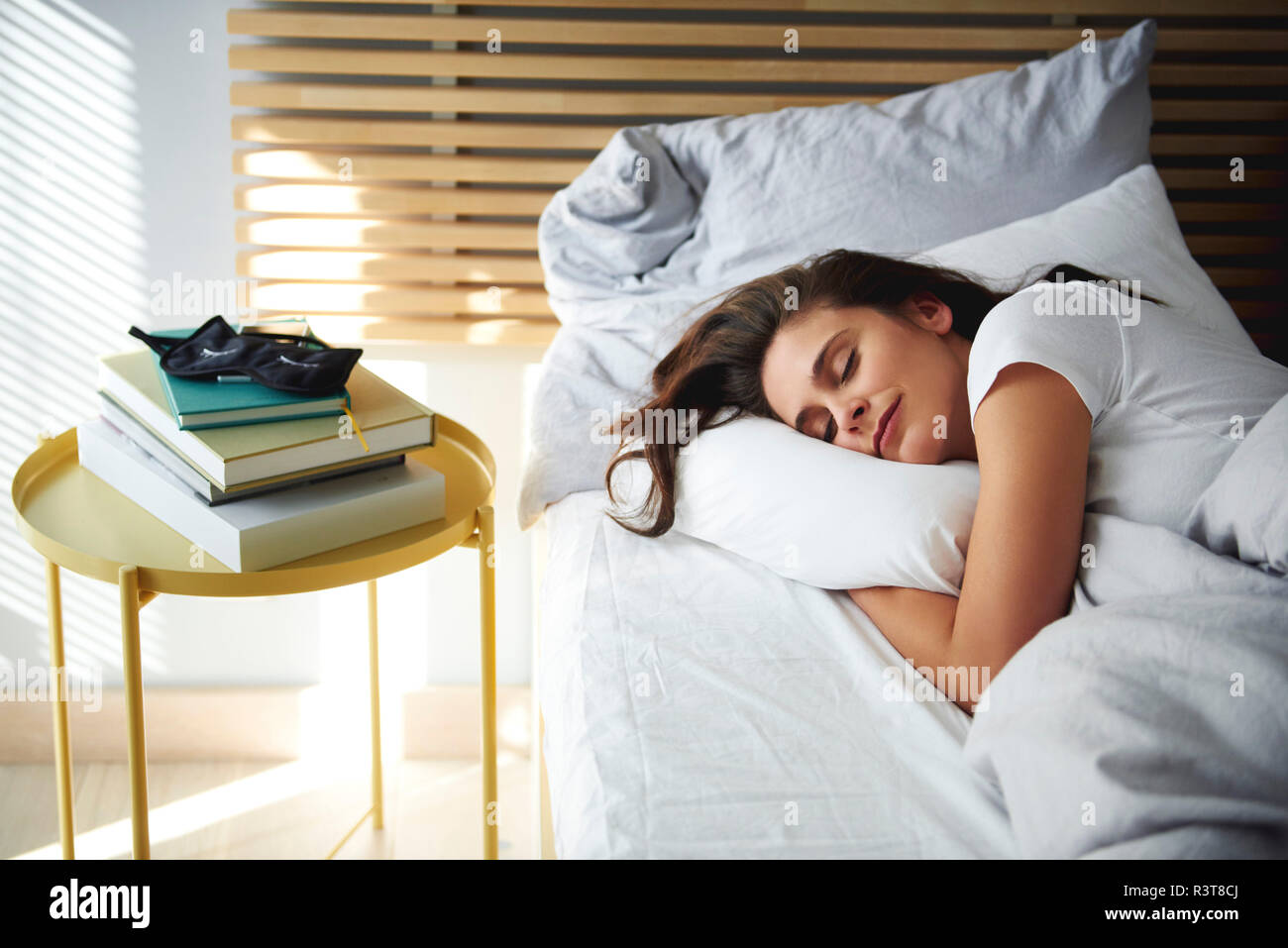 Portrait of woman sleeping in bed by daylight Stock Photo