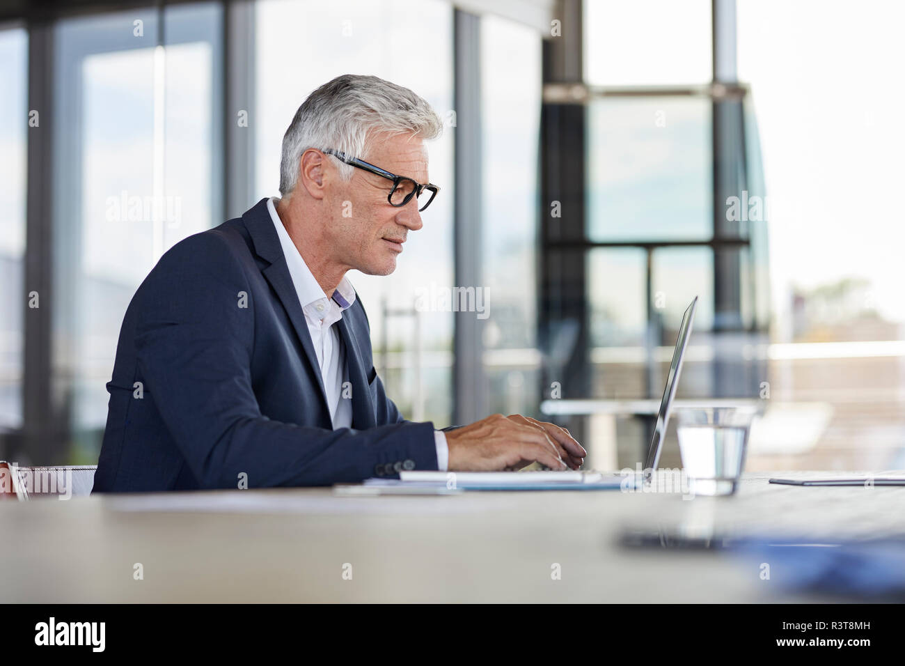 Businessman working in office, using laptop Stock Photo
