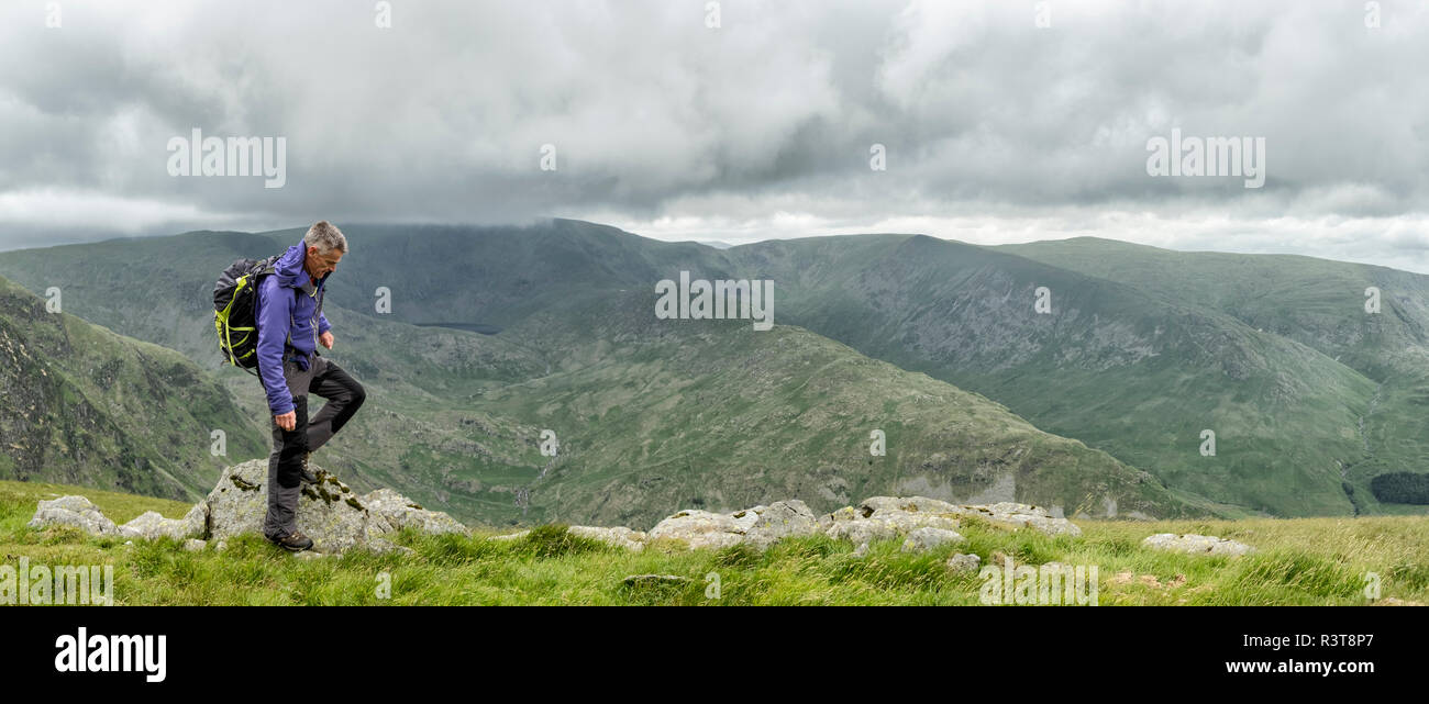 UK, Lake District, Longsleddale valley, mature man with backpack in rural landscape Stock Photo
