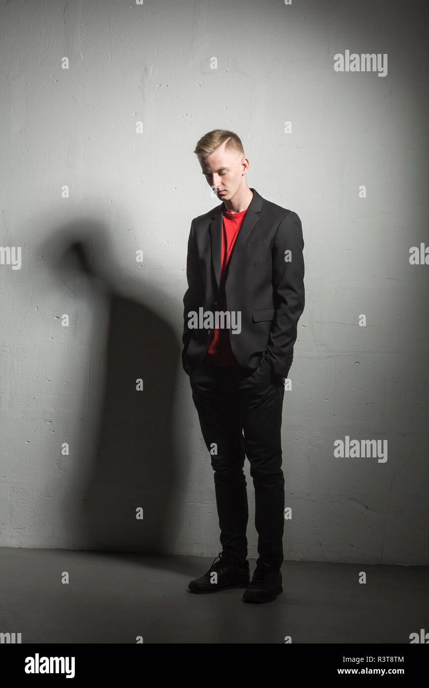 Young man wearing black suit and red t-shirt Stock Photo