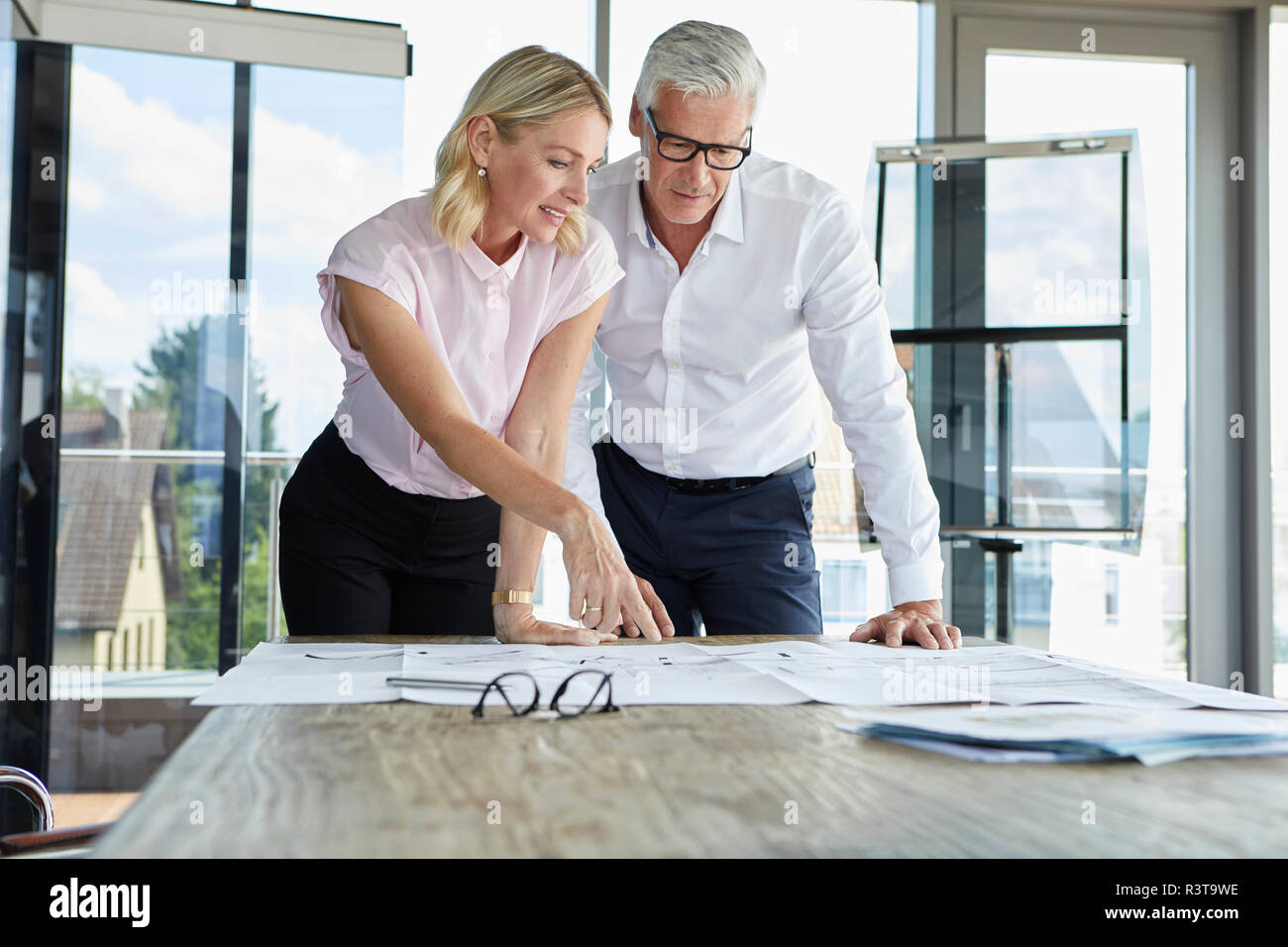 Businessman and woman discussing project in office Stock Photo