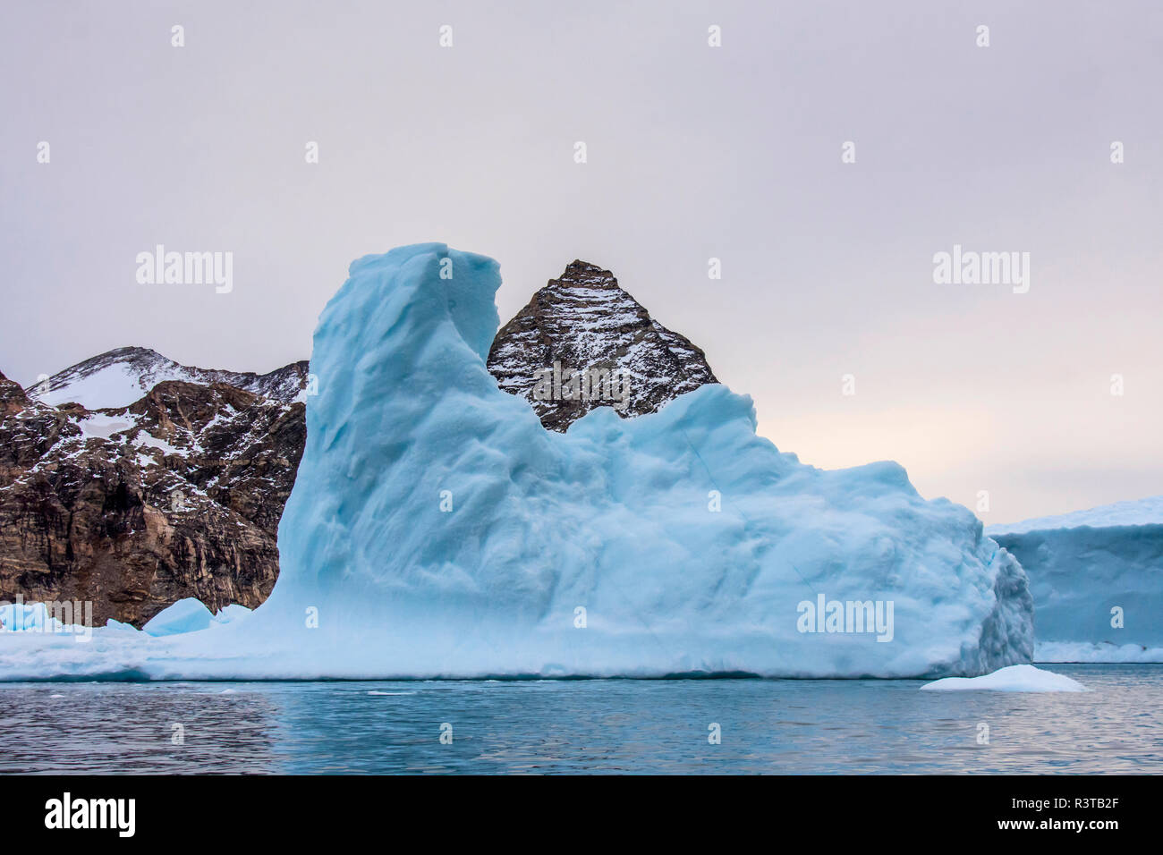 Greenland. East Greenland. Liverpool Land. Warming Island. Dense blue iceberg. Stock Photo