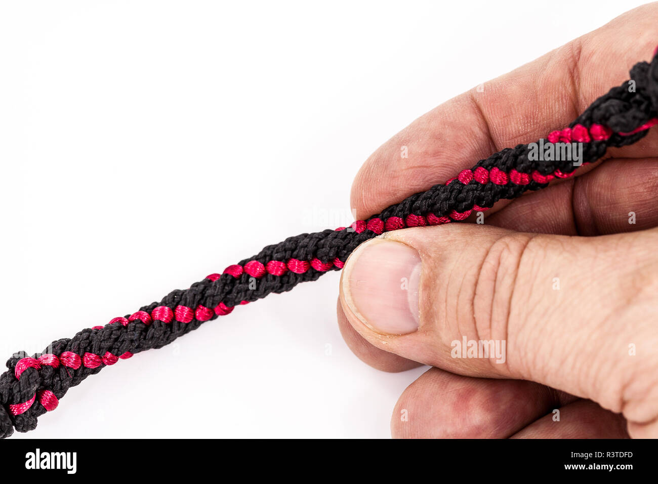 the red thread,held like a pen. Stock Photo