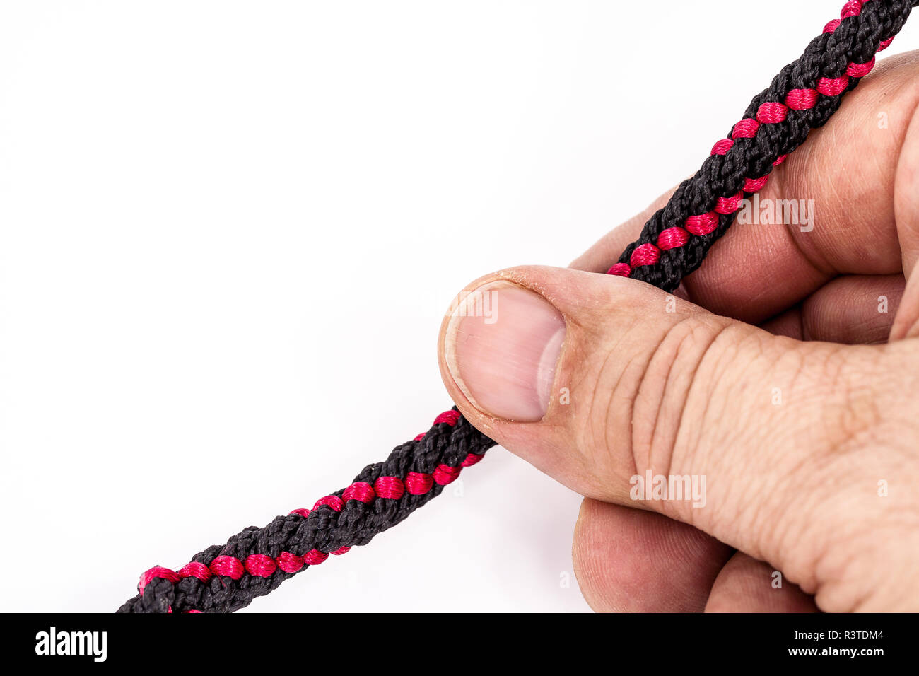 thumb on the red thread. Stock Photo