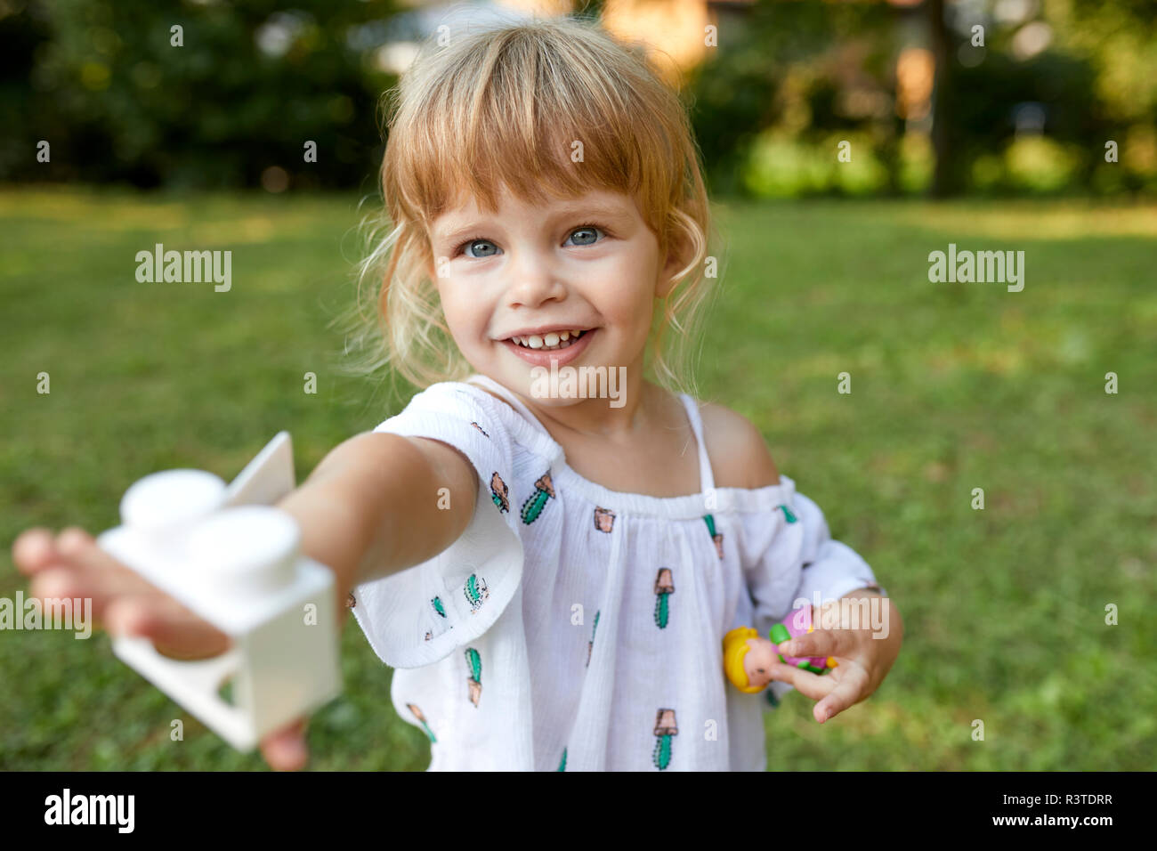Portrait of cute little girl in garden Stock Photo