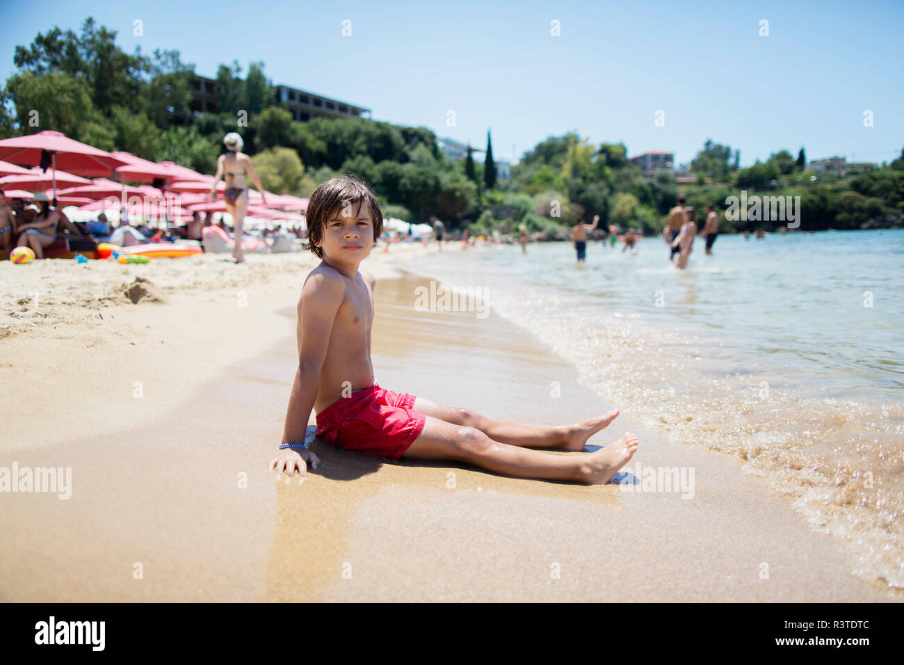 Portrait of a boy sitting on the beach Stock Photo