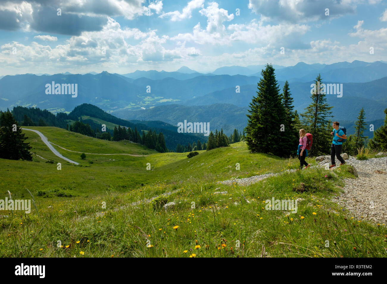 Germany, Bavaria, Brauneck near Lenggries, young couple hiking in alpine landscape Stock Photo