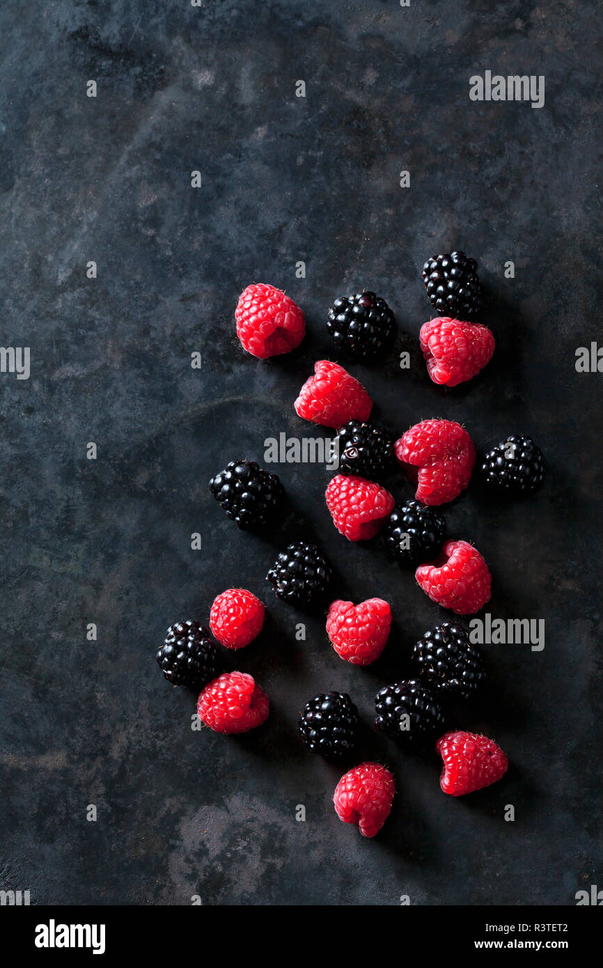 Blackberries and raspberries on dark background Stock Photo