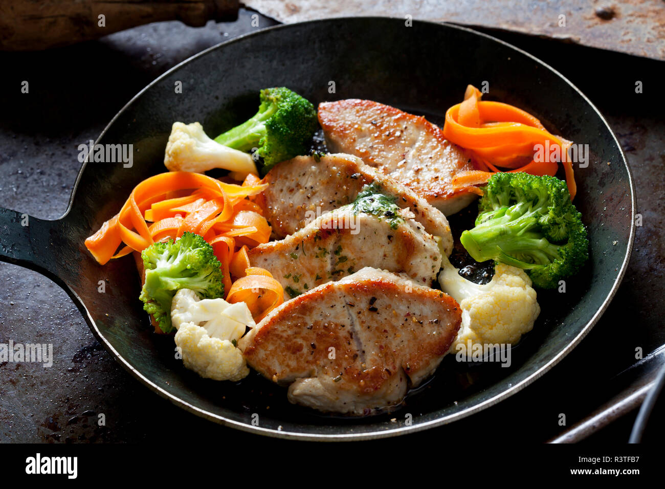 Fillet of turkey and vegetables in pan Stock Photo