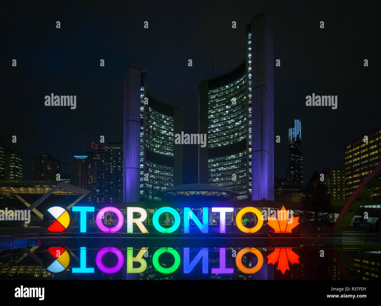 A night view of the 3D TORONTO sign, Toronto City Hall (New City Hall), and Nathan Phillips Square in downtown Toronto, Ontario, Canada. Stock Photo