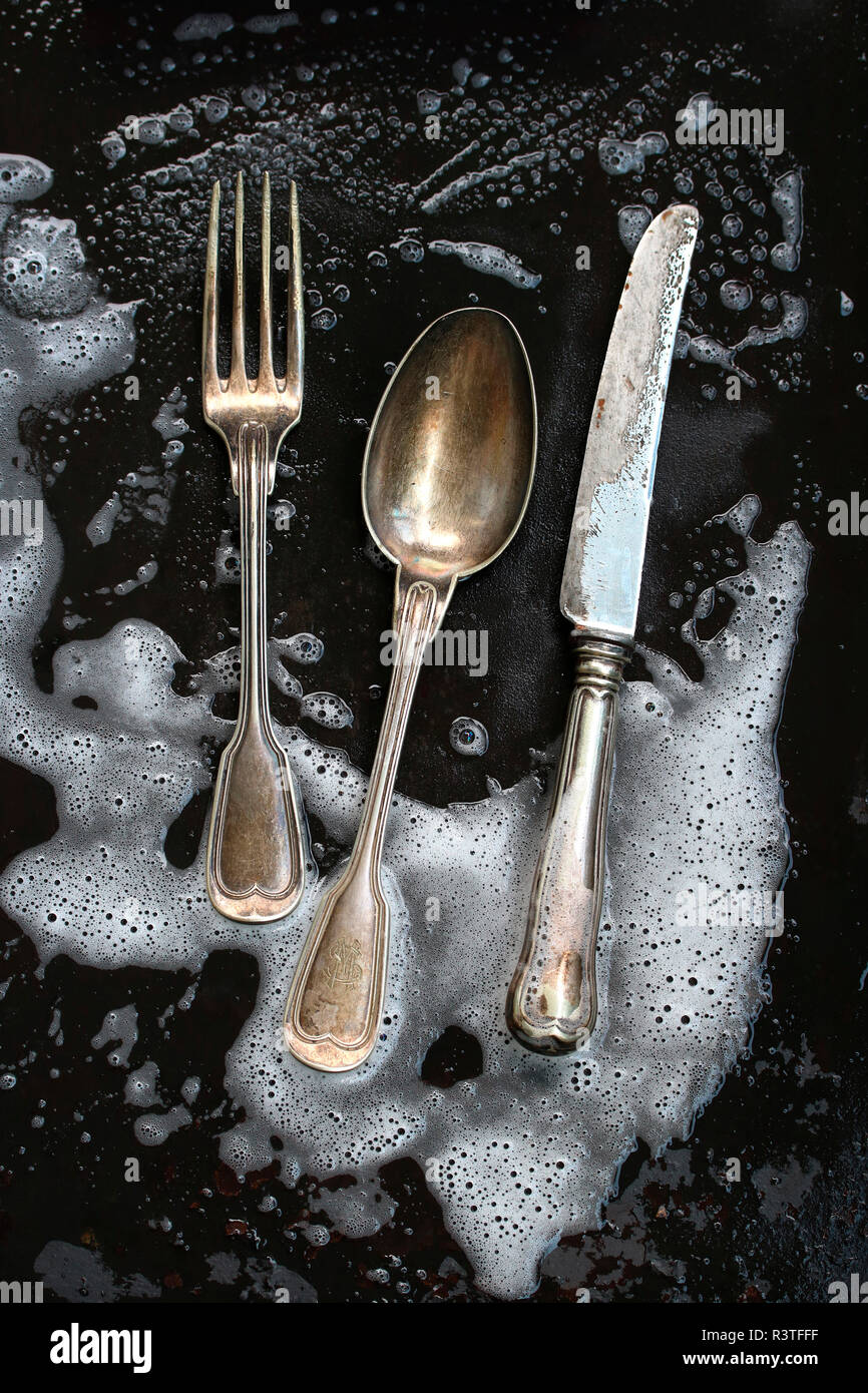 Silver cutlery getting cleaned Stock Photo