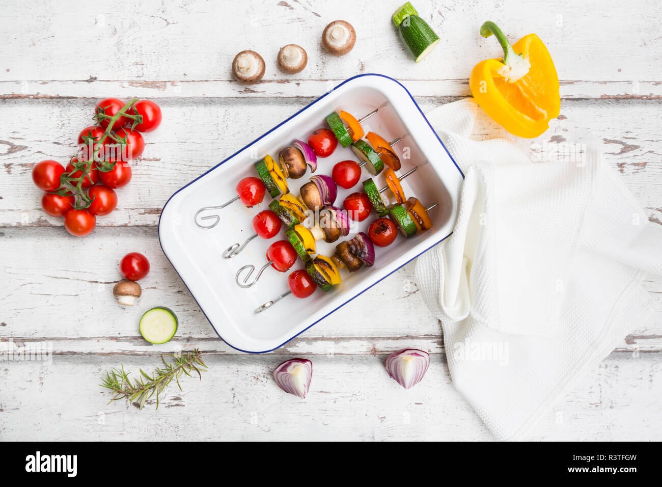 Vegetarian grill spits, orange and yellow paprika, tomato, red onion ...