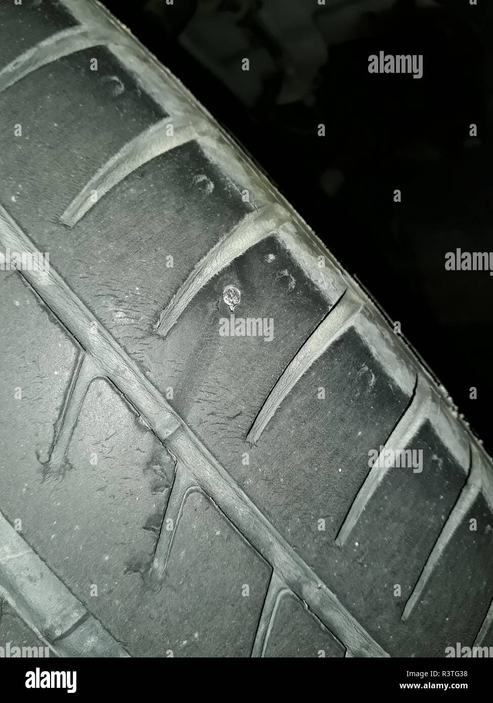 The Nail Or Selftapping Bites Of A Black Rubber Tire Of An Old Car Is Part  Of A Wheel That Has Damage Stock Photo - Download Image Now - iStock