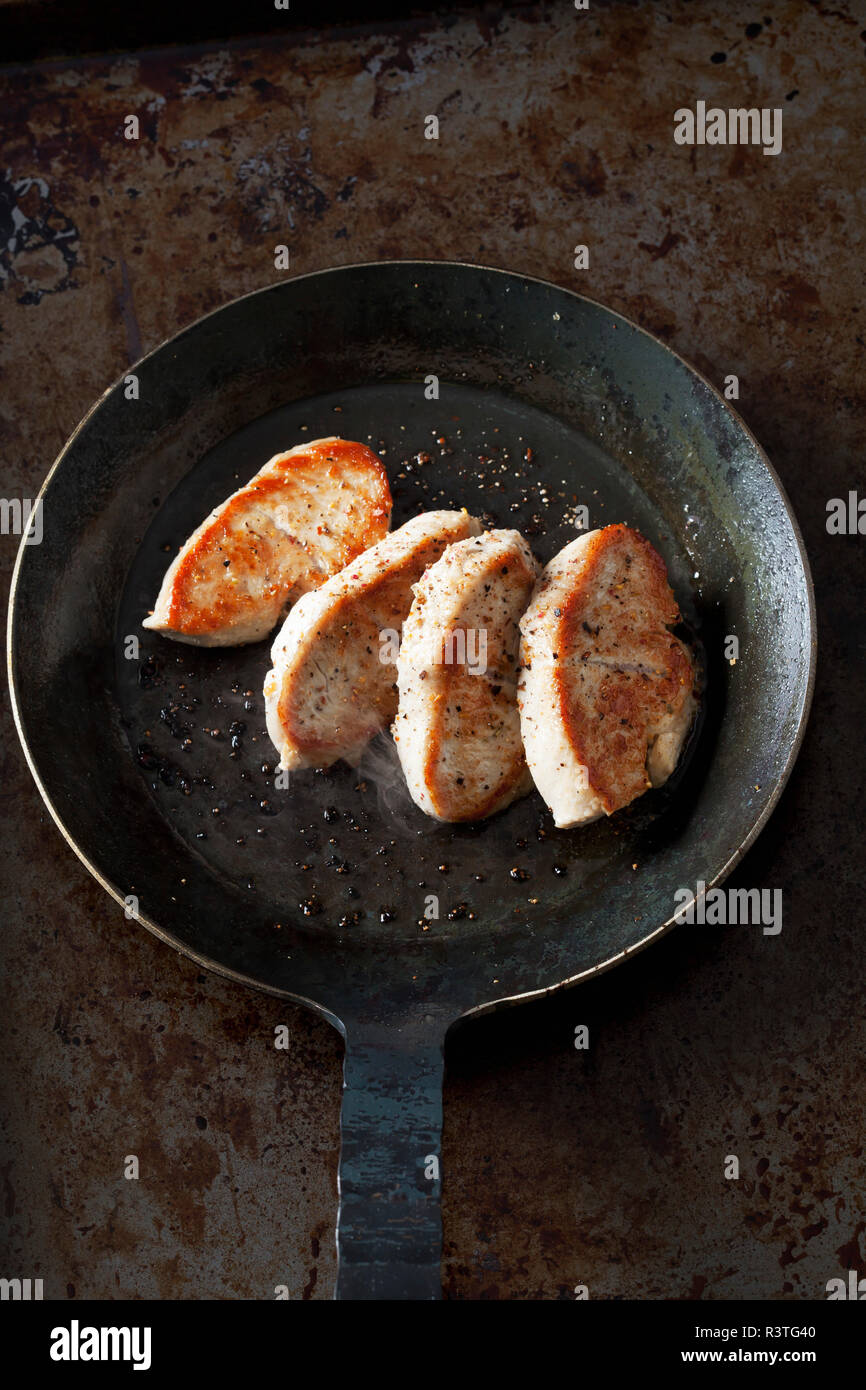 Fillet of turkey in pan Stock Photo Alamy