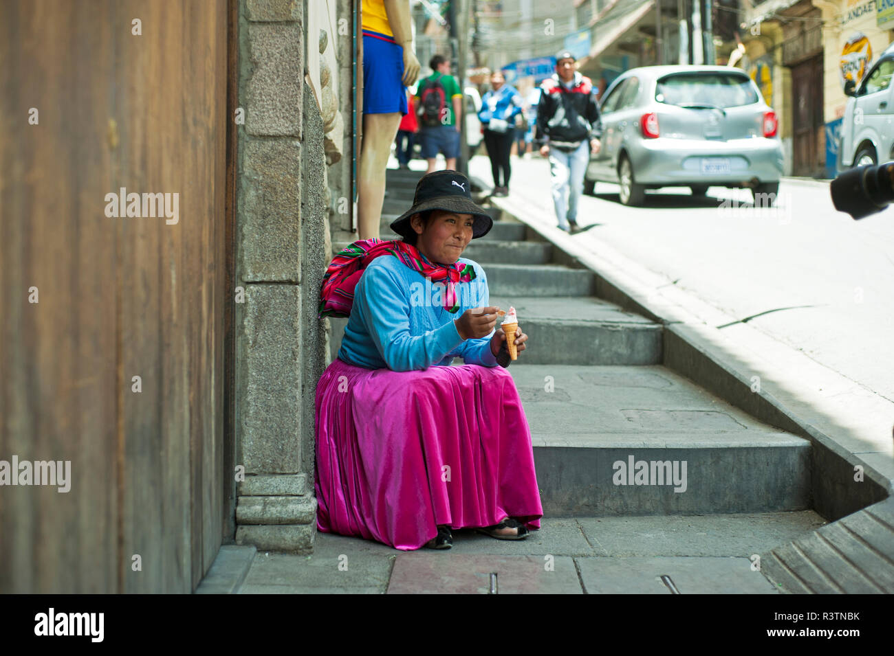 Local Aymara woman eating ice cream, La Paz, Bolivia Stock Photo