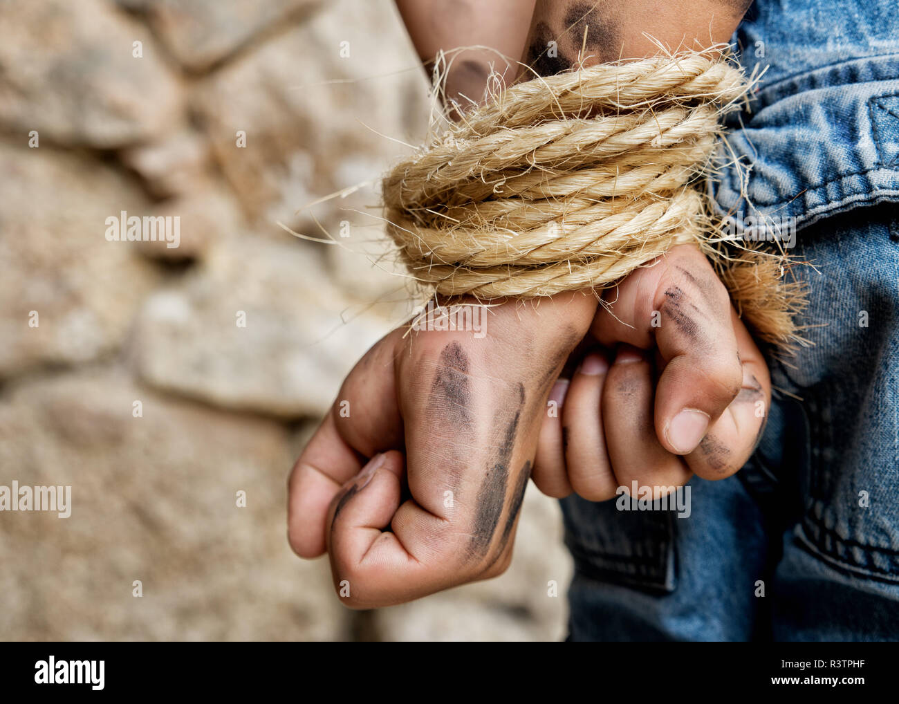 Prisoner bound with rope Stock Photo