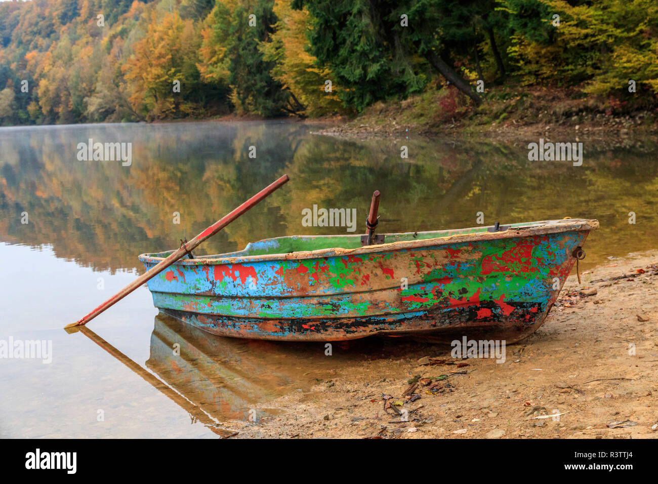 Maramures County, Romania. Baia Mare. Firiza. Lake Firiza. Fall color. Rowboat on shore. Stock Photo