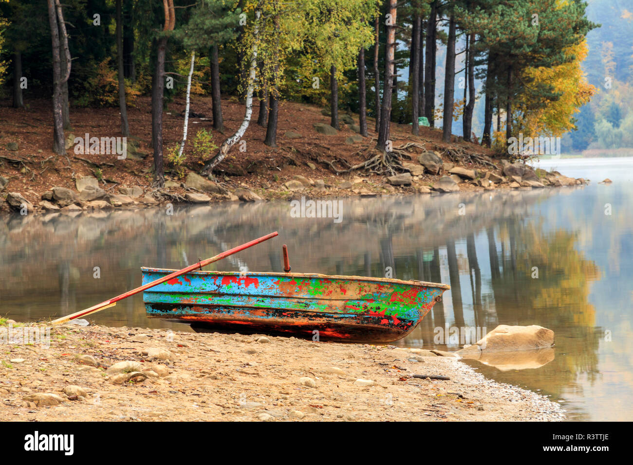 Maramures County, Romania. Baia Mare. Firiza. Lake Firiza. Fall color. Rowboat on shore. Stock Photo