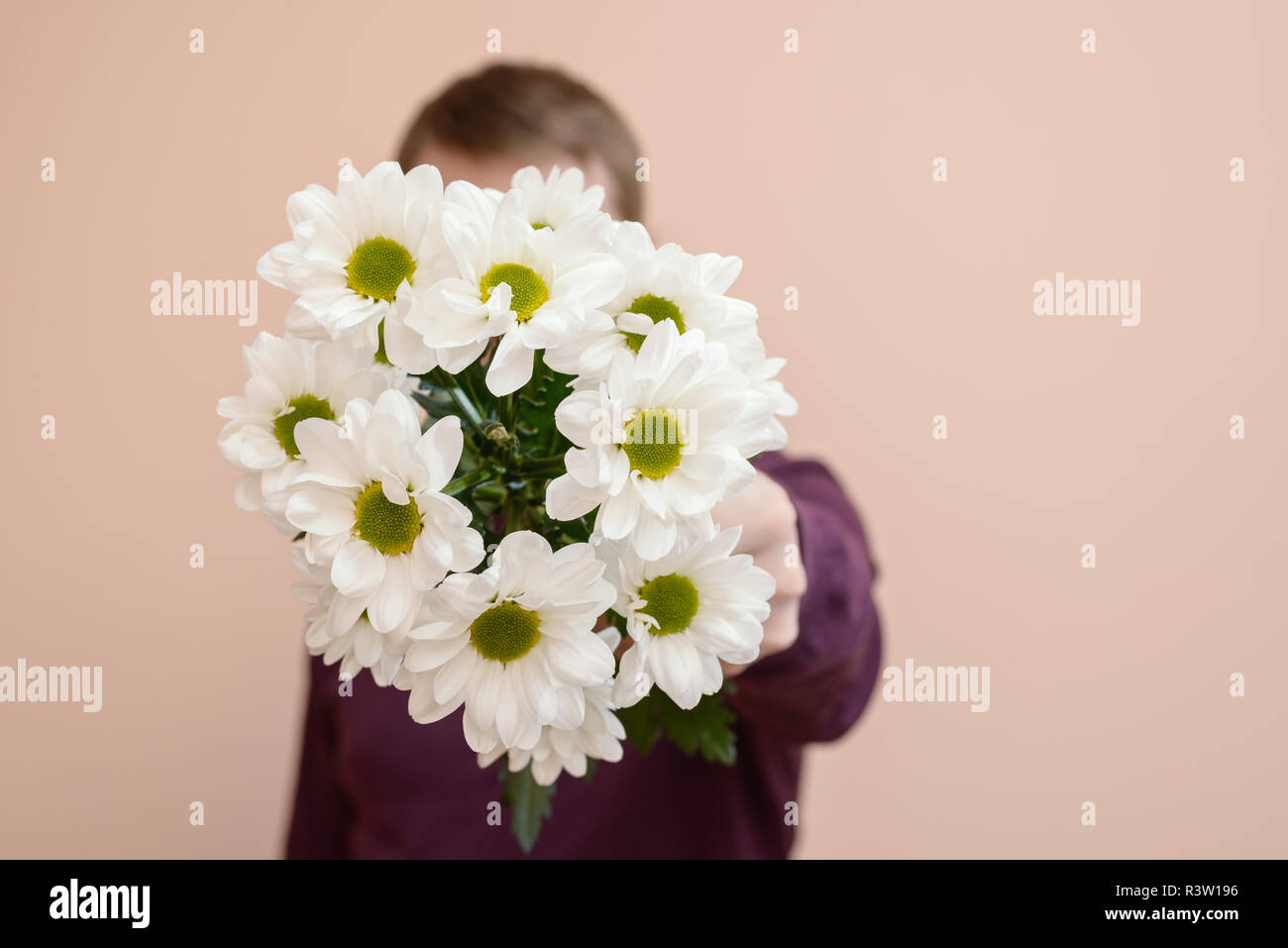 Young man with white flowers in his hand. Stock Photo