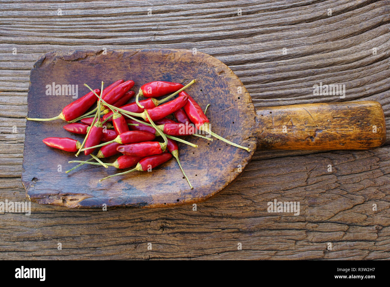 small chili peppers on ancient spice shovel Stock Photo Alamy