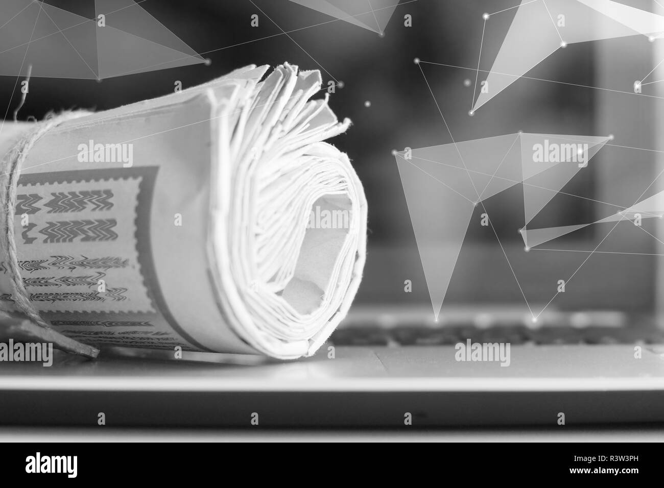 Laptop and newspapers with virtual abstract poligon projection. Digital