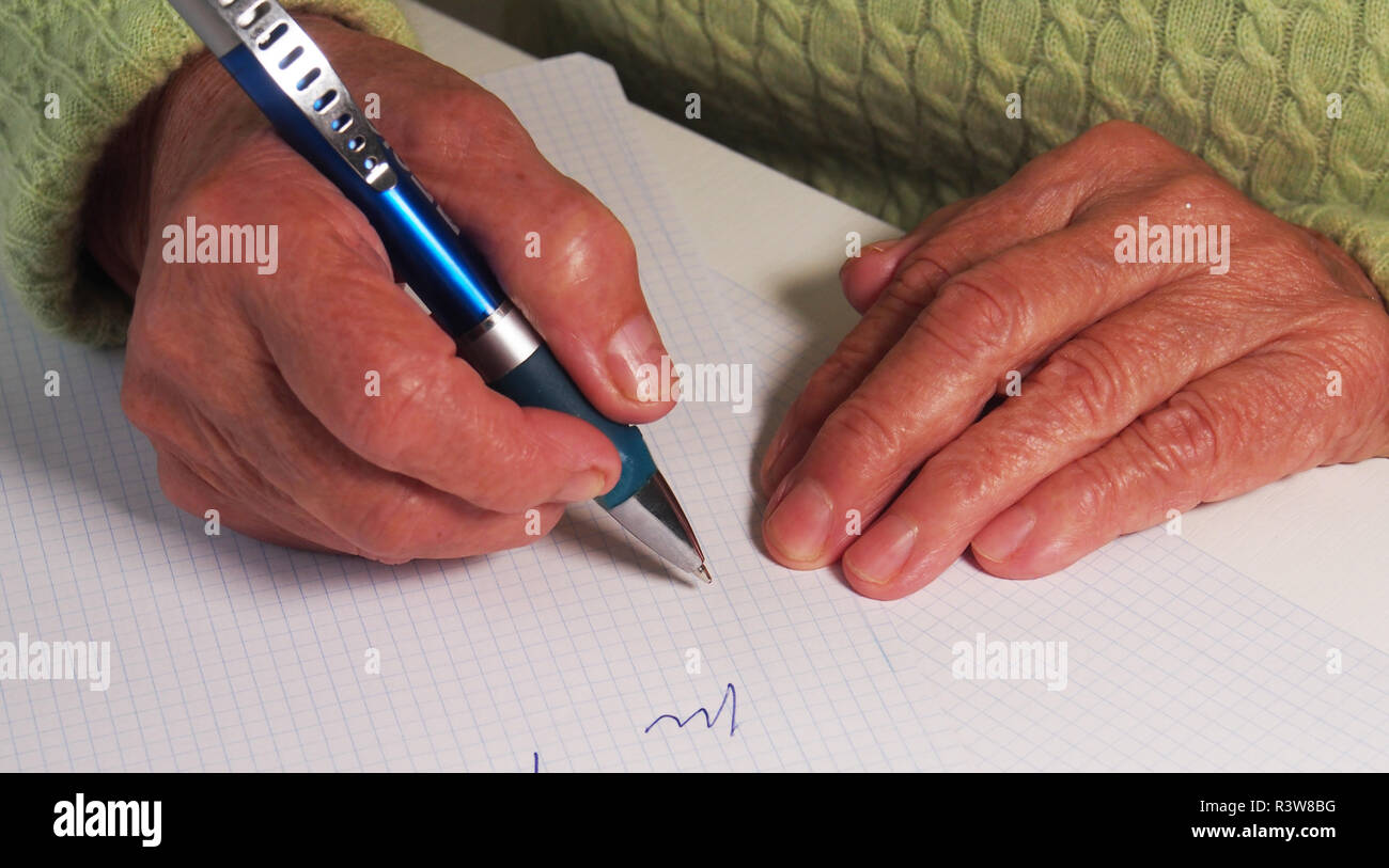 Elderly woman writing on blank paper stock photo alamy
