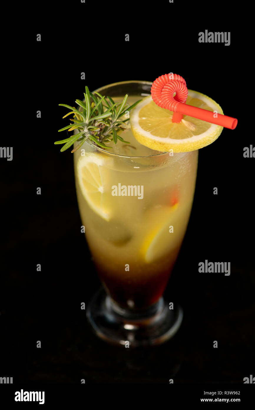 Long Island cocktail with vodka, tequila, rum, cin and lime juice with isolated black background