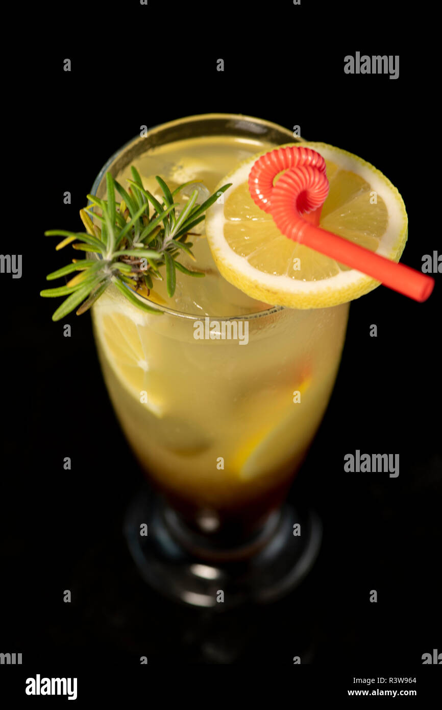 Long Island cocktail with vodka, tequila, rum, cin and lime juice with isolated black background