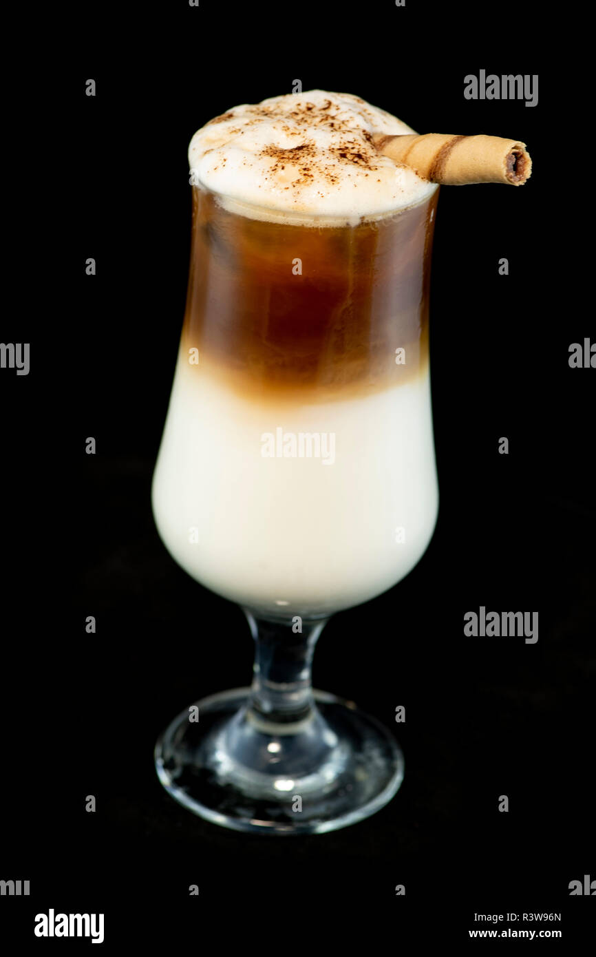 Alcoholic coffee cocktail with coffee liqueur, fresh cream and milk with isolated black background Stock Photo