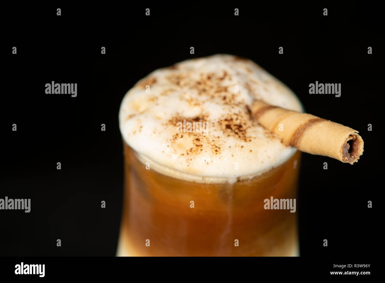 Alcoholic coffee cocktail with coffee liqueur, fresh cream and milk with isolated black