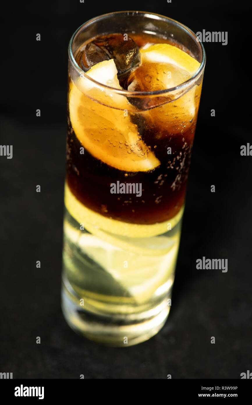 Cuba Libre cocktail with rum, coke and lime juice with lime wedge and