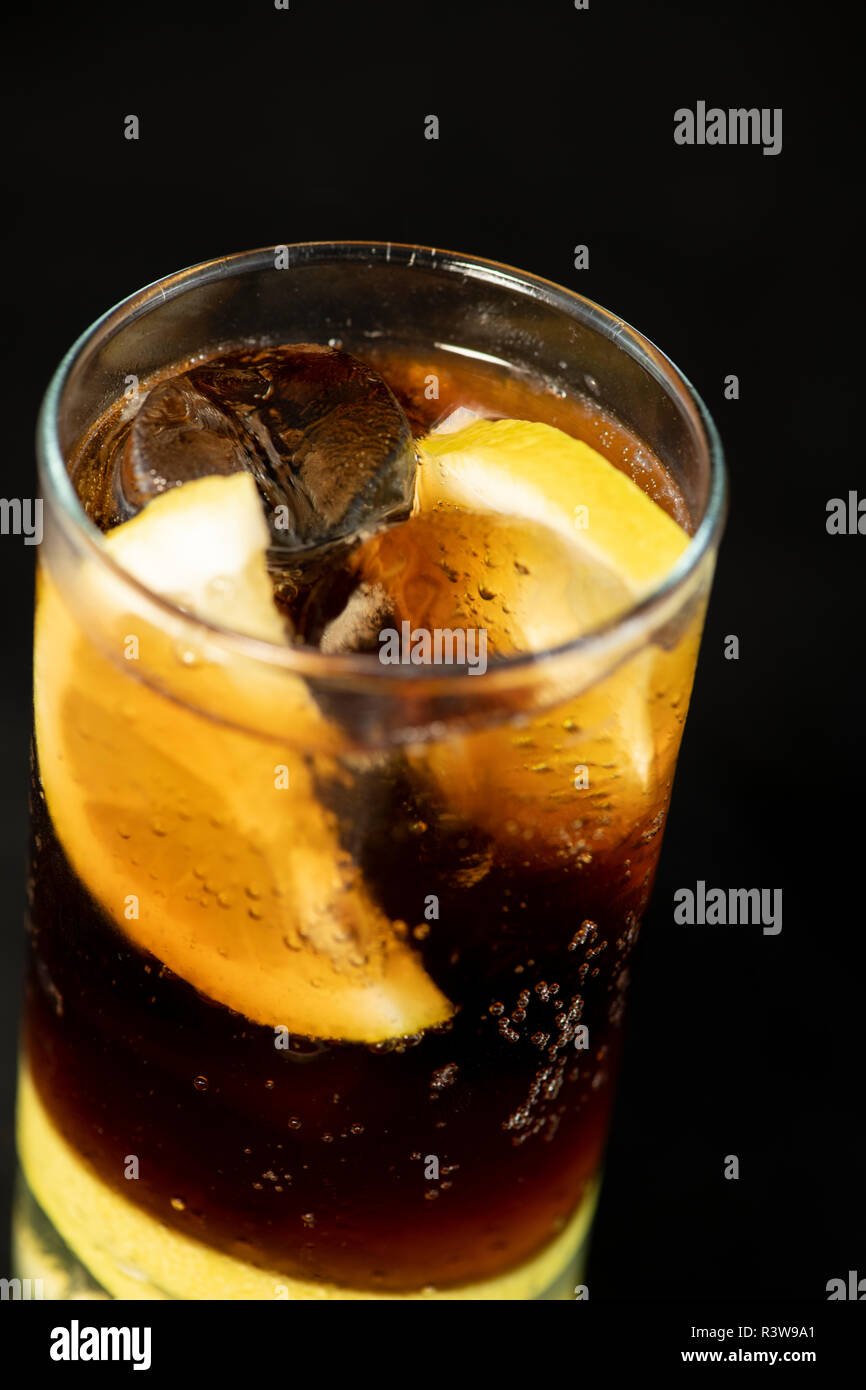 Cuba Libre cocktail with rum, coke and lime juice with lime wedge and