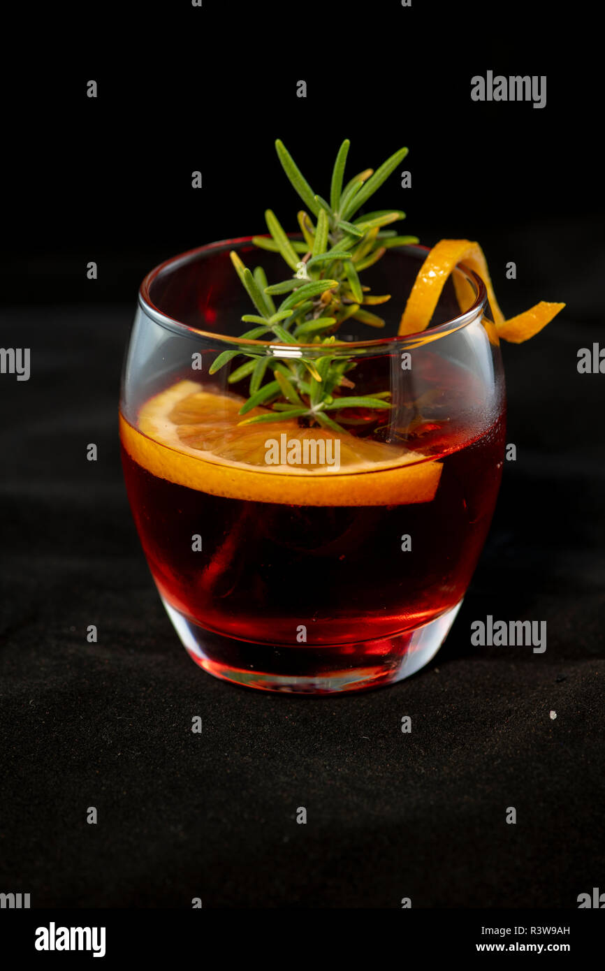 Gotfather cocktail with bourbon whiskey, amaretto, orange wedge and