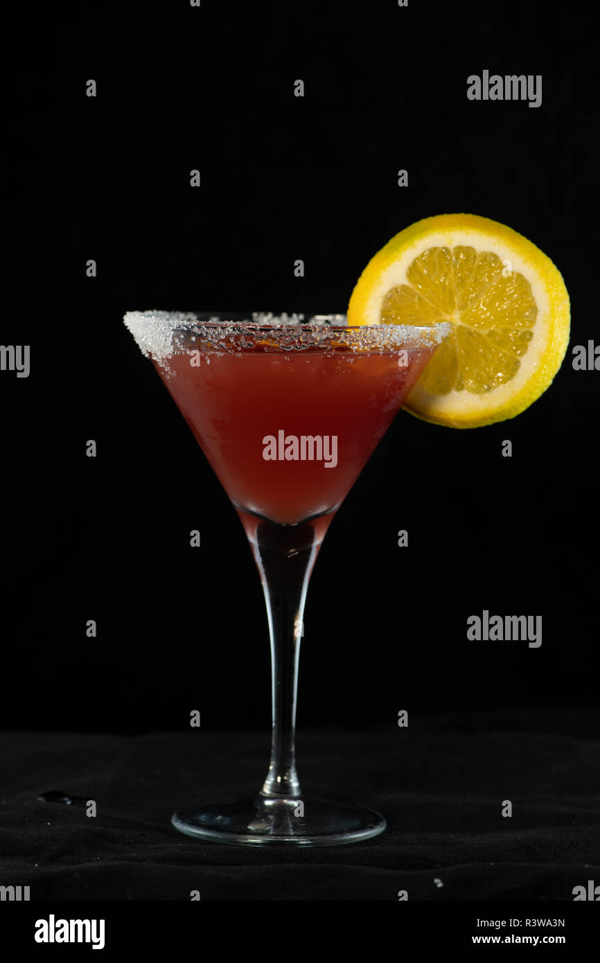 Cosmopolitan Cocktail with cranberry juice, vodka, lime juice and cointreau with isolated black background Stock Photo